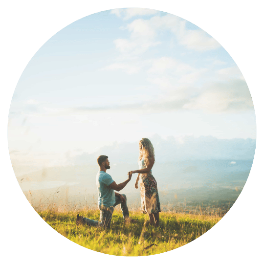 maui-photography-client-review-nick A man on one knee proposing on a grassy Maui hilltop above the clouds