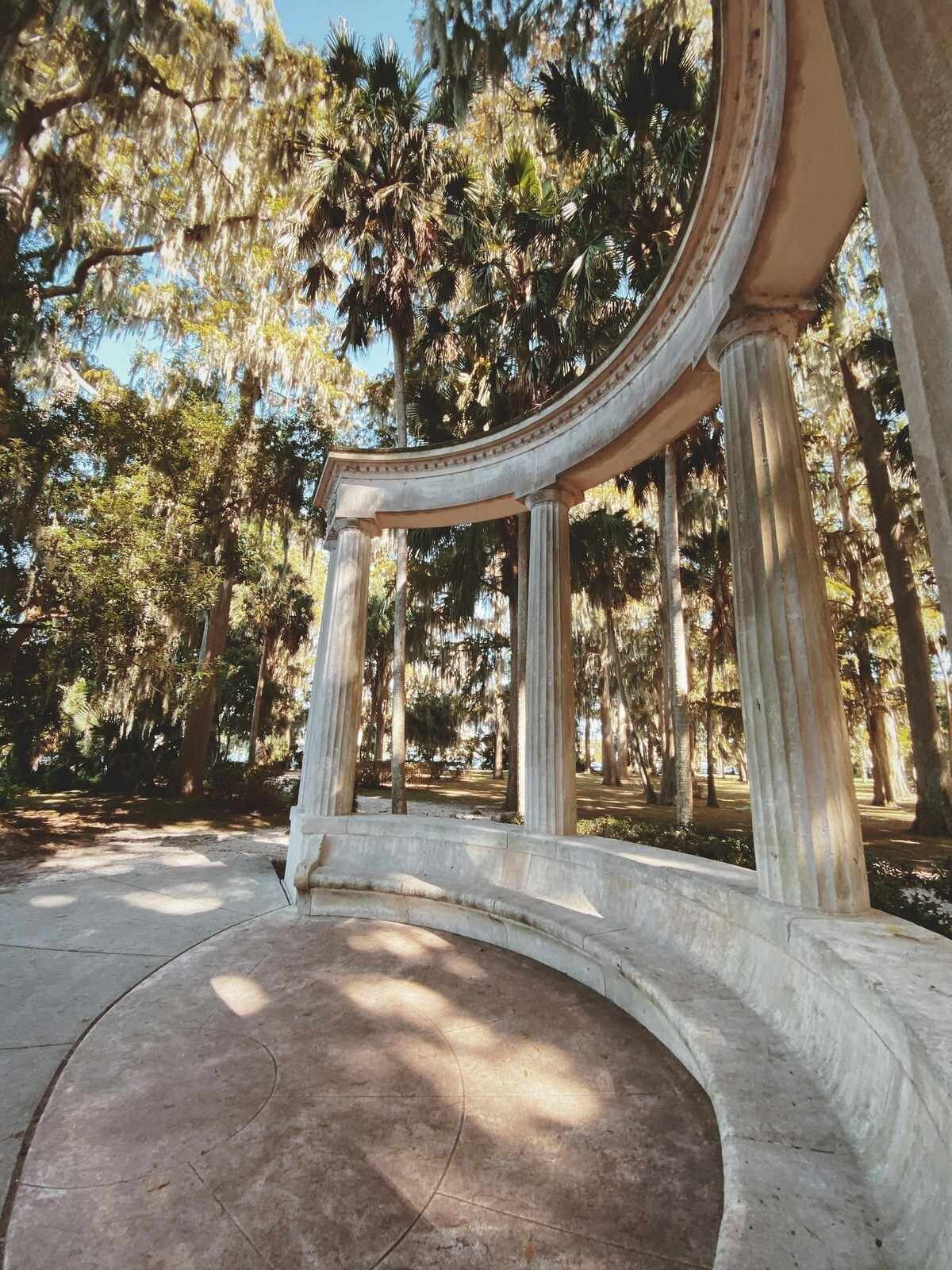 The stone monument and columns at Kraft Azalea Garden in Winter Park, a popular Orlando engagment photography location surrounded by Spanish moss and cypress trees