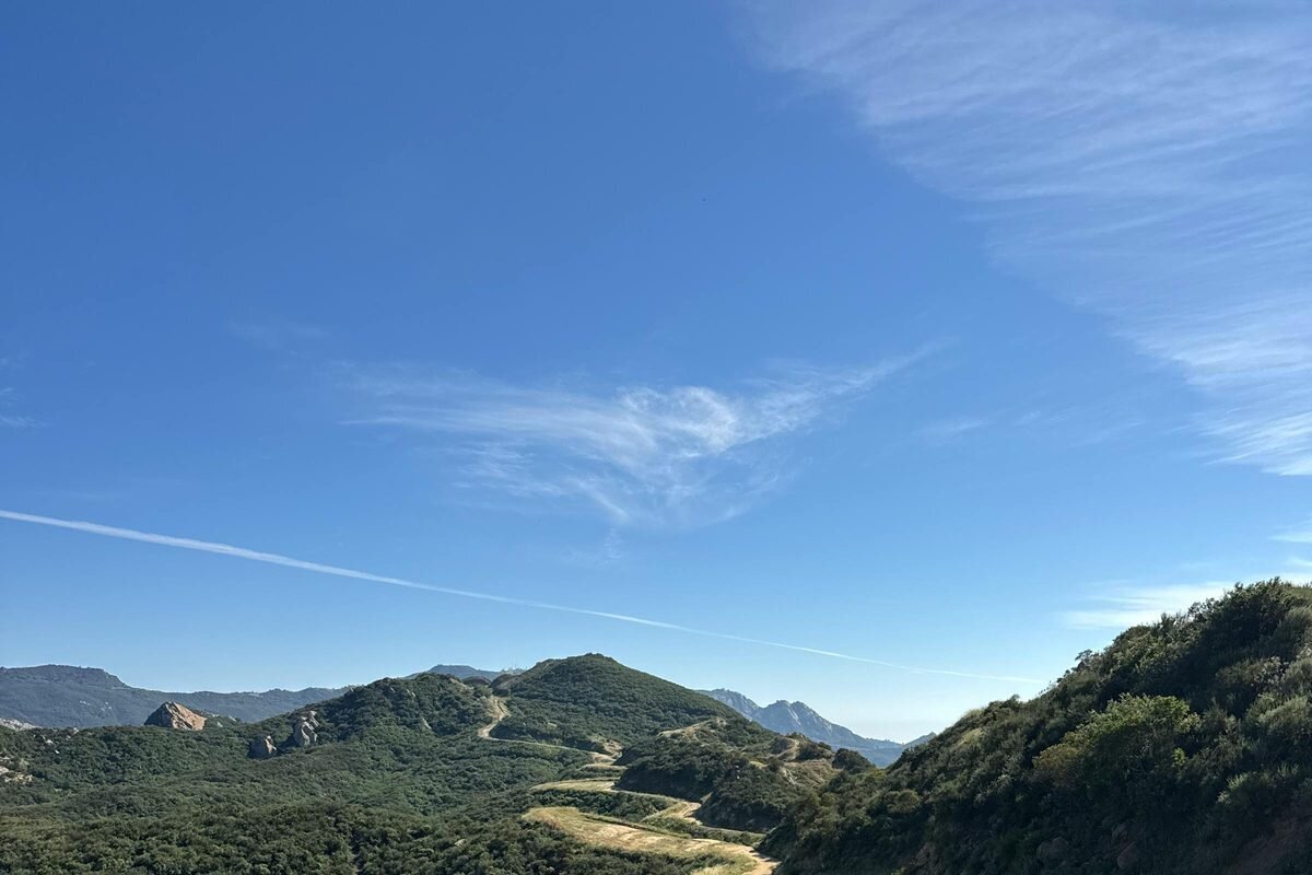 Rolling green hills and golden chaparral valley at Malibu Creek State Park, a stunning Los Angeles family photography location in the Santa Monica Mountains