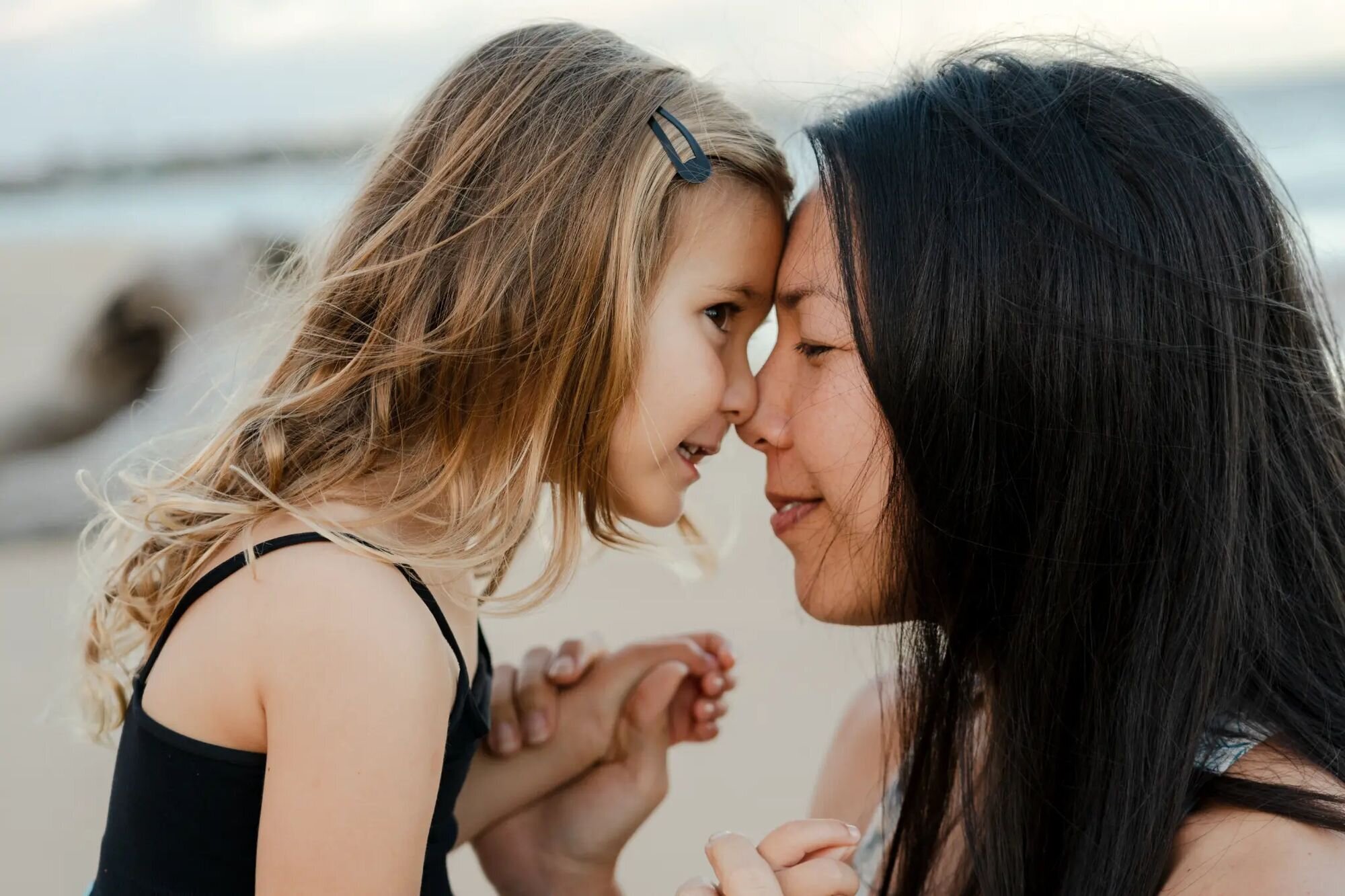 Mother & daughter forehead-to-forehead