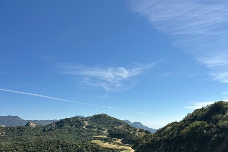 Rolling green hills and golden chaparral valley at Malibu Creek State Park, a stunning Los Angeles family photography location in the Santa Monica Mountains
