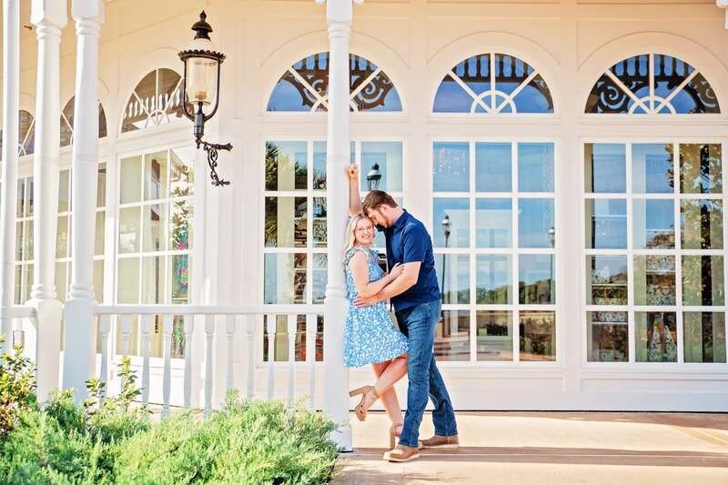 A couple dancing together in front of a charming white building in Orlando Florida during a romantic photoshoot
