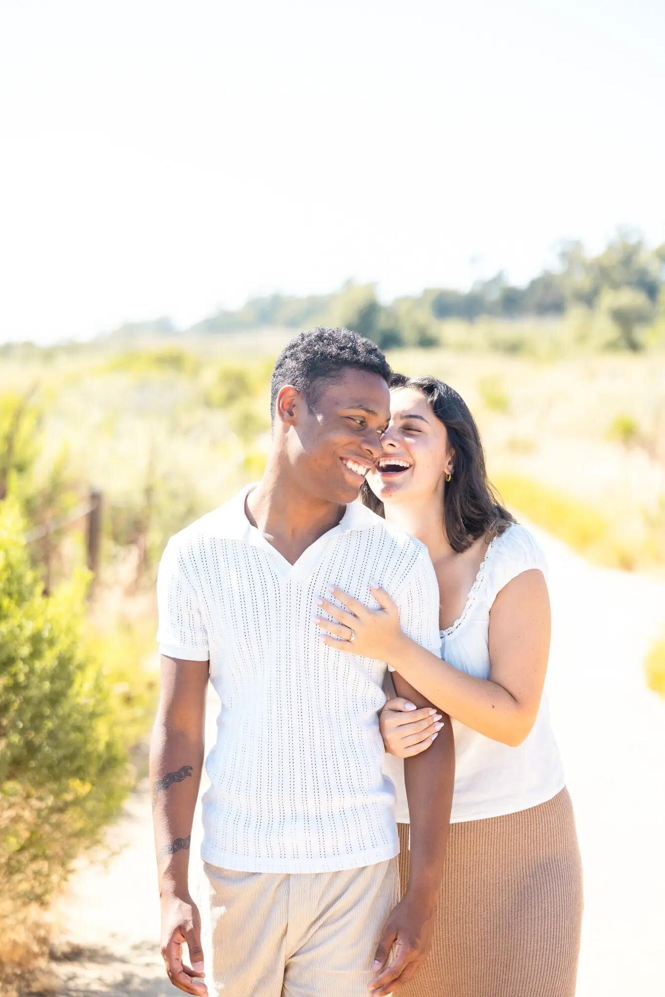 A couple laughing together naturally during a candid vacation photography session