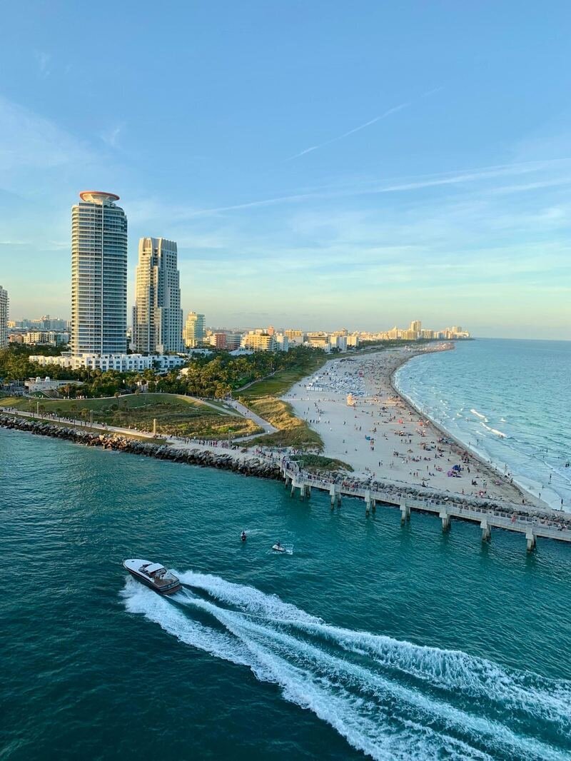 Aerial view of South Pointe Park in Miami Beach with turquoise water, sandy beach, and the South Beach skyline in the background
