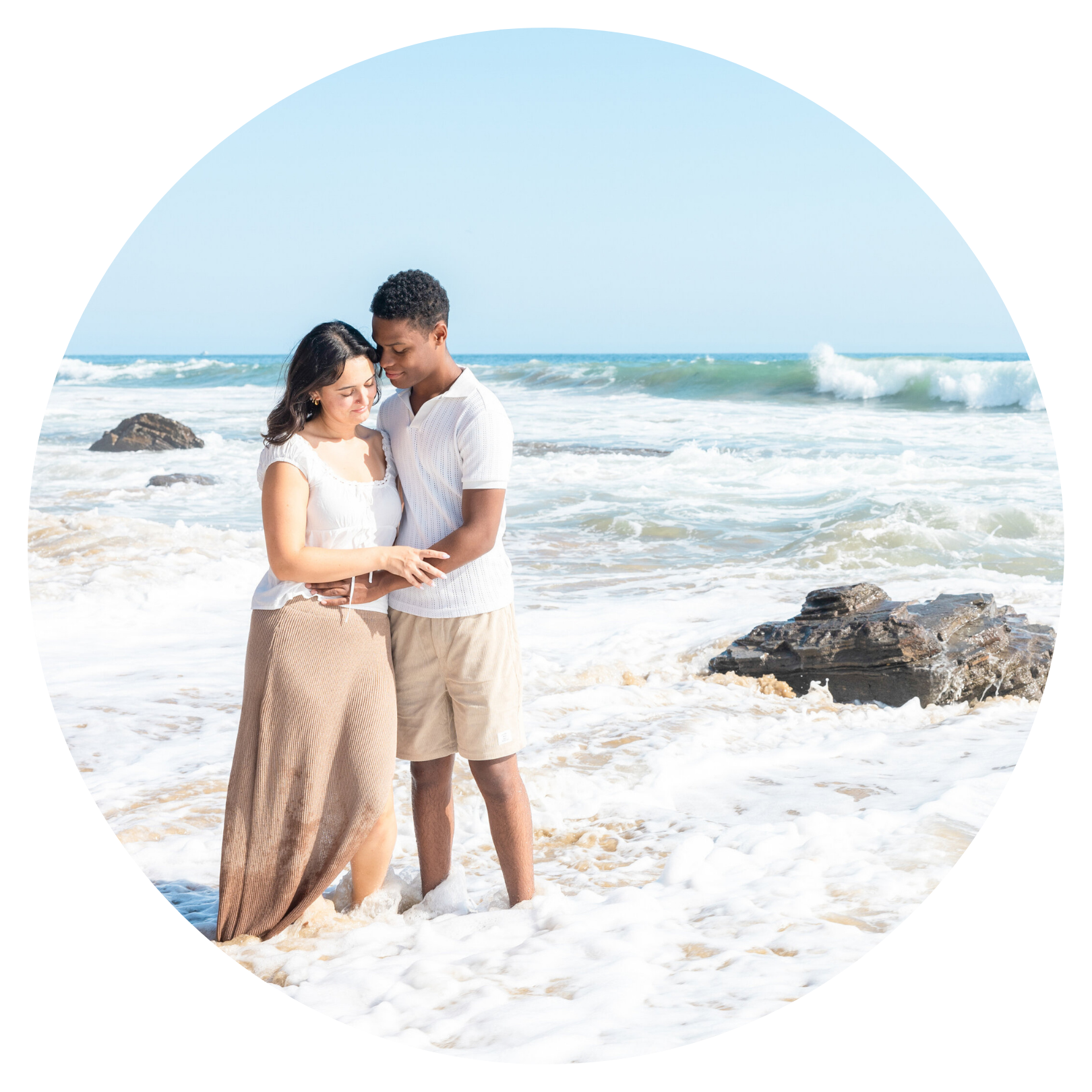 Couple embracing with waves behind — vacation photography client Michelle