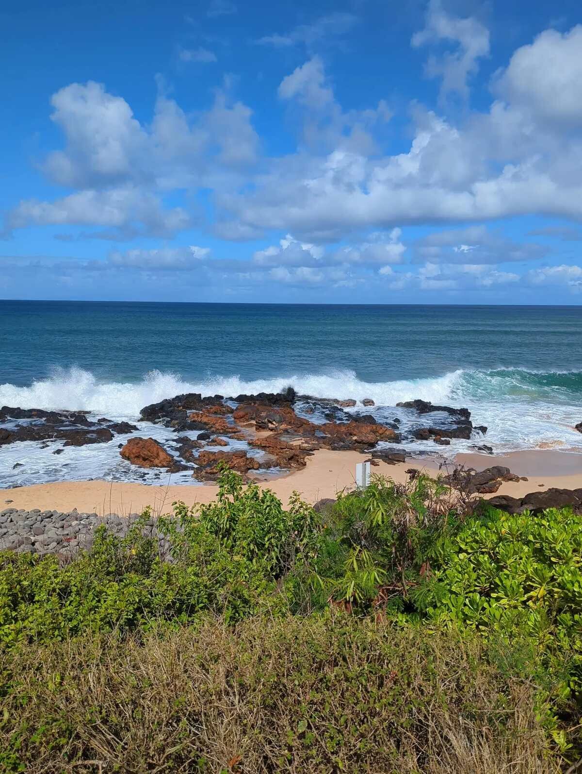 Dramatic lava rock coastline with crashing waves at Ironwoods Beach in Maui, a location for engagement photos and surprise proposals