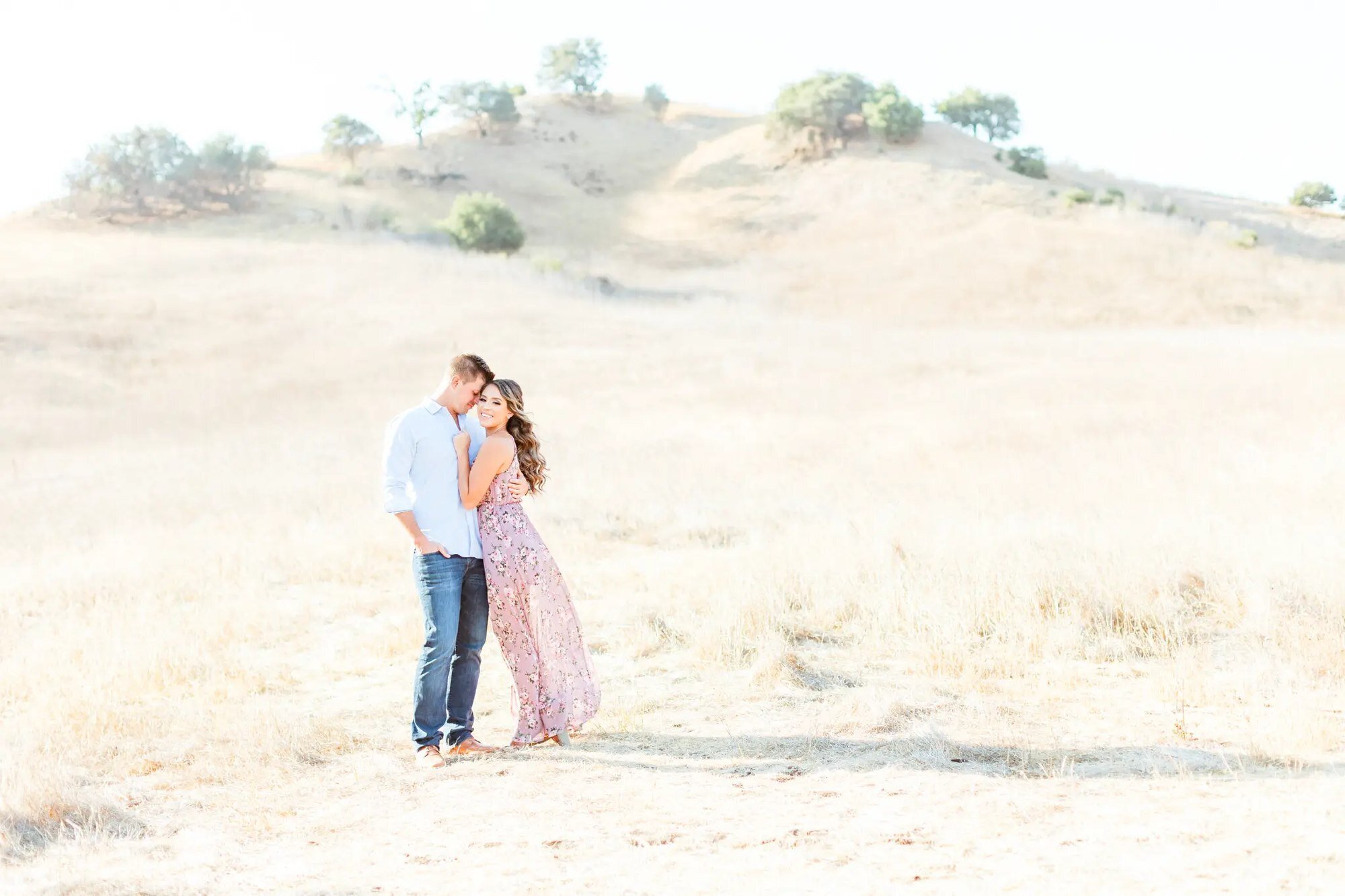 Los Angeles Photographer — Couples Session at Malibu Creek State Park Los Angeles photographer capturing a couple embracing in a golden dry grass field with rolling hills at Malibu Creek State Park