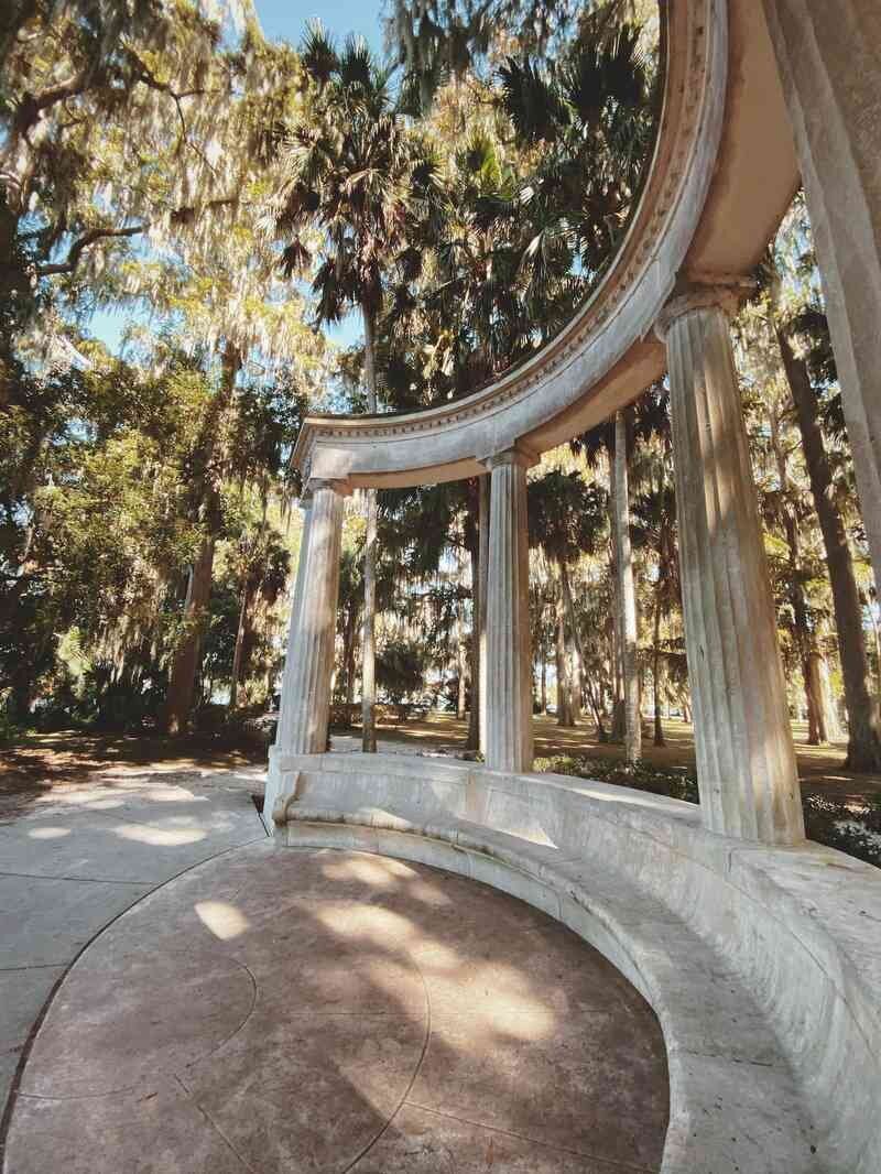 The stone monument and columns at Kraft Azalea Garden in Winter Park, a popular Orlando family photography location surrounded by Spanish moss and cypress trees