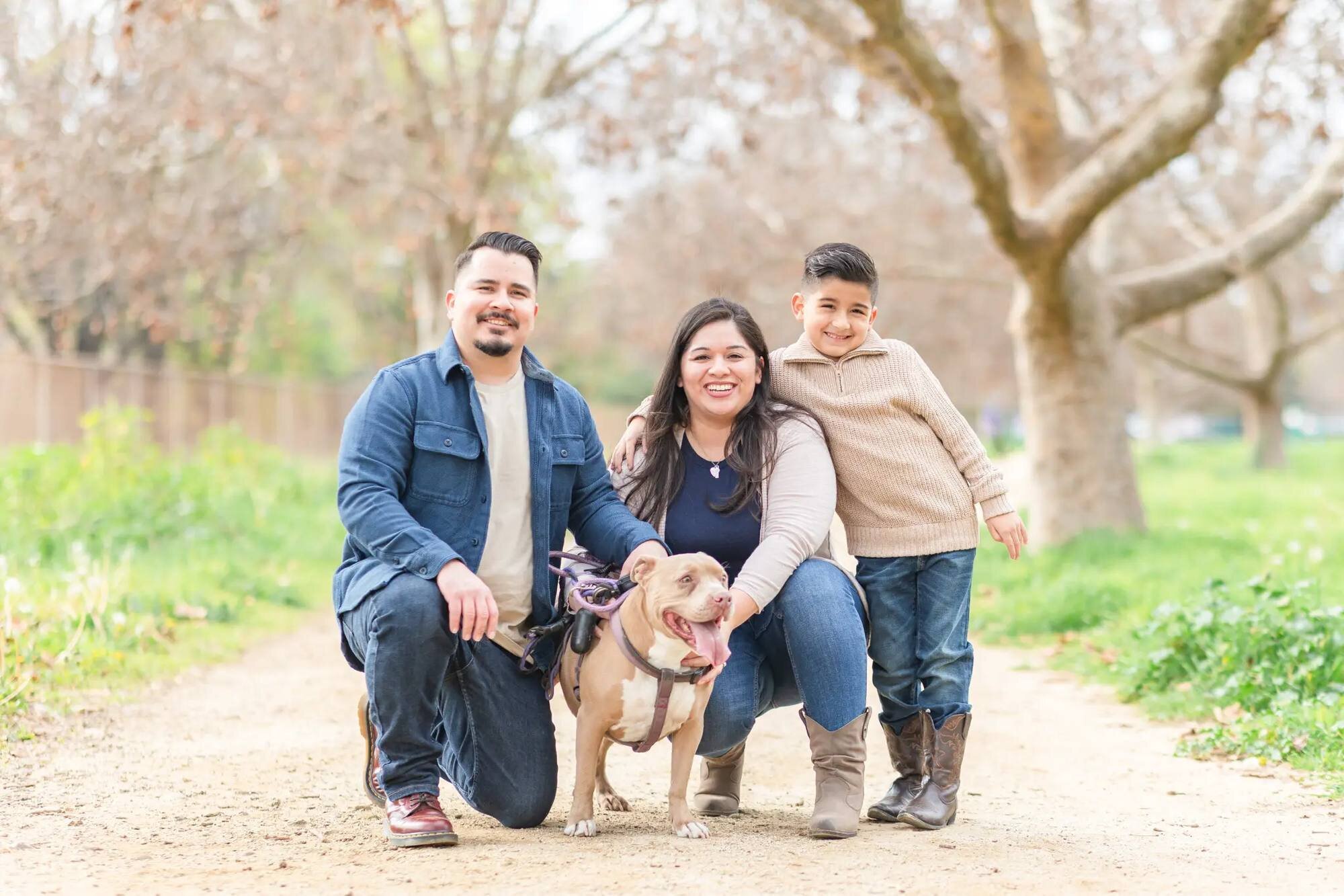 Los Angeles Photographer — Family Session at Lake Balboa Park Los Angeles photographer capturing a family of three with their dog posing together on a tree-lined dirt path at Lake Balboa Park