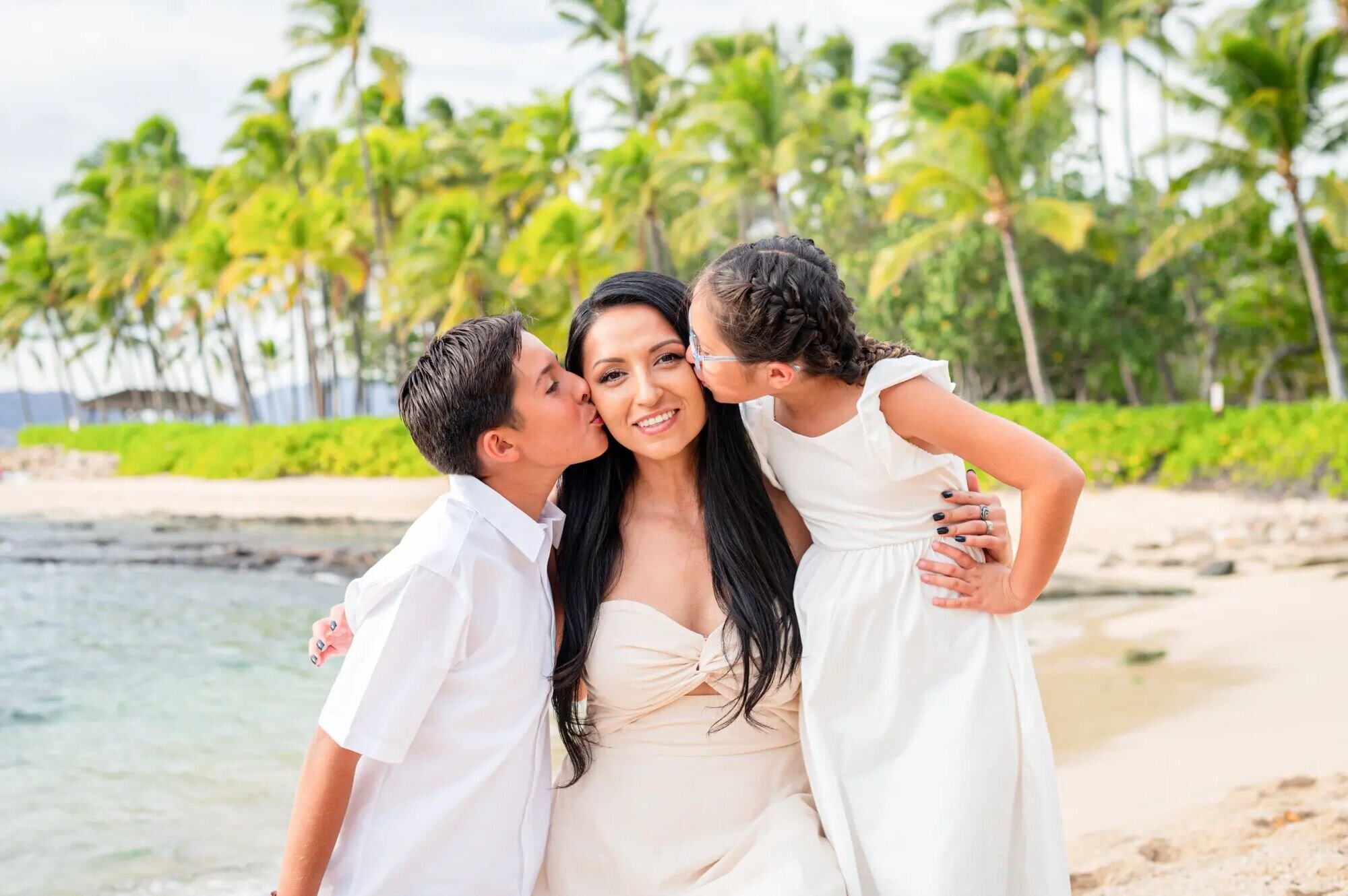 A mother hugging her young daughter during a candid vacation family photography session