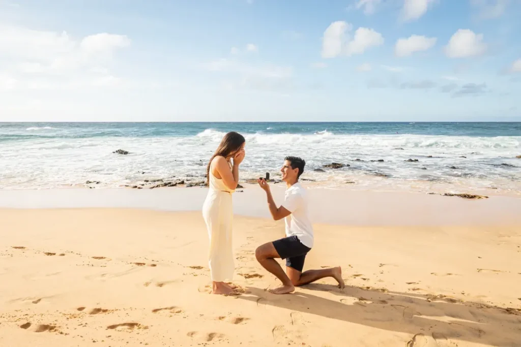 Man proposing on a Hawaii beach at golden hour, illustrating the best places to propose in Hawaii