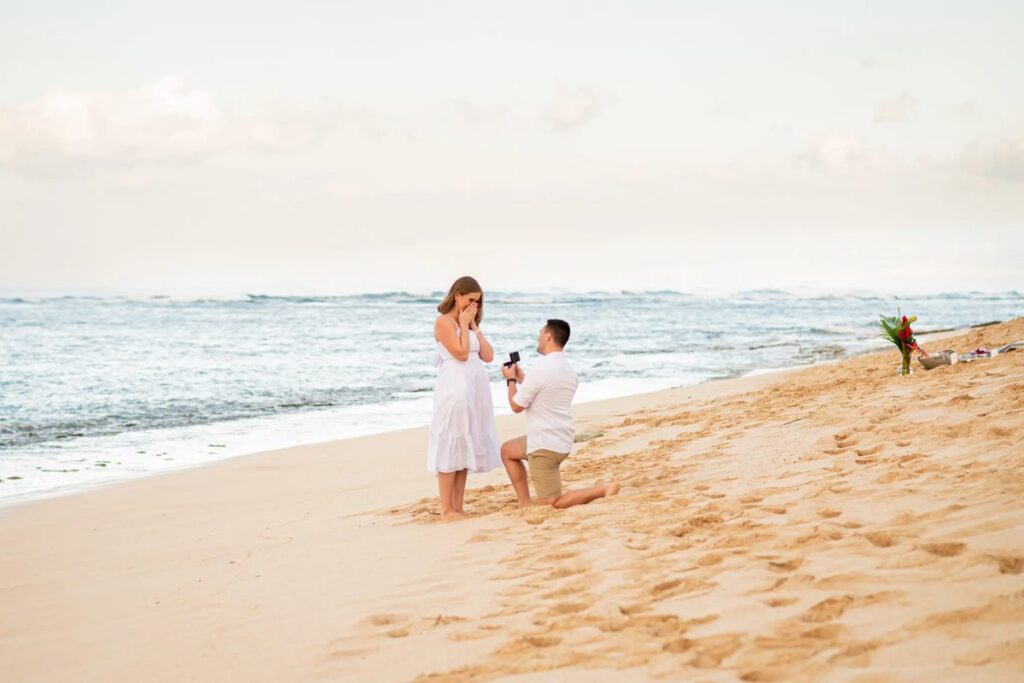 A classic golden hour beach proposal in Maui with an empty beach and perfect lighting for engagement photos.
