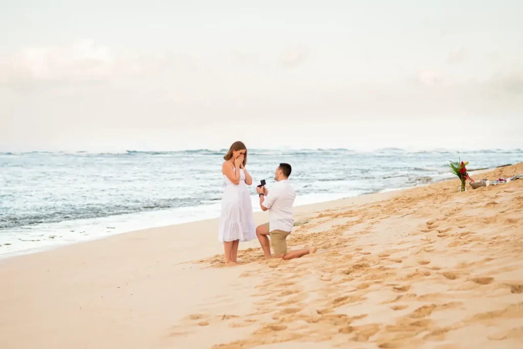 Proposal at Mākua Beach Oahu photographed discreetly from a distance, showing the hiding-in-plain-sight approach